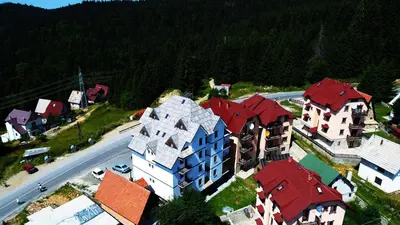 an aerial view of a town with houses and a road at Dobricin Konak Apartmani in Kopaonik