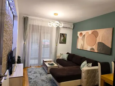 a living room with a couch and a table at Alex apartman in Vrnjačka Banja