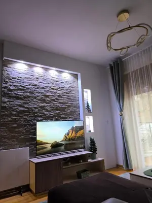 a living room with a large flat screen tv at Alex apartman in Vrnjačka Banja