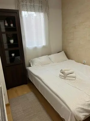 a bedroom with a bed with two towels on it at Holiday Lux Apartment in Soko Banja