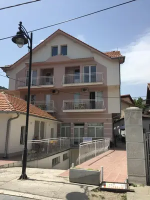 a large house with balconies and a street light at Holiday Lux Apartment in Soko Banja