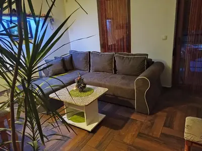a living room with a couch and a table at Smiley Apartman in Vrnjačka Banja