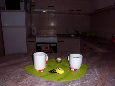 two cups sitting on a table in a kitchen at Smiley Apartman in Vrnjačka Banja