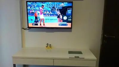 a flat screen tv hanging on a wall at Smiley Apartman in Vrnjačka Banja