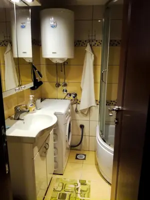 a small bathroom with a sink and a shower at Smiley Apartman in Vrnjačka Banja