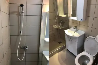 a bathroom with a shower and a toilet and a sink at Apartments Ivan in Niš