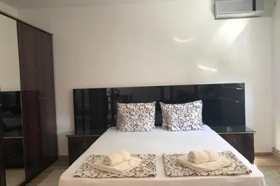 a bedroom with a bed with two towels on it at Apartments Ivan in Niš