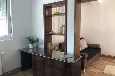 a living room with a dresser and a chair at Apartments Ivan in Niš