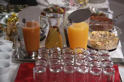 a table topped with glasses and bottles of orange juice at Zepter Spa Wellness Hotel & Zepterme member of Zepter Hotels in Vrnjačka Banja