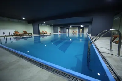 a large swimming pool in a building at Zepter Spa Wellness Hotel & Zepterme member of Zepter Hotels in Vrnjačka Banja