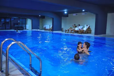 a group of people in a swimming pool at Zepter Spa Wellness Hotel & Zepterme member of Zepter Hotels in Vrnjačka Banja