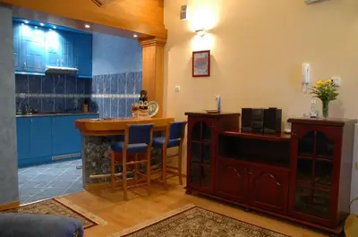 a kitchen with a bar with blue cabinets at Hotel Tehnograd in Kraljevo