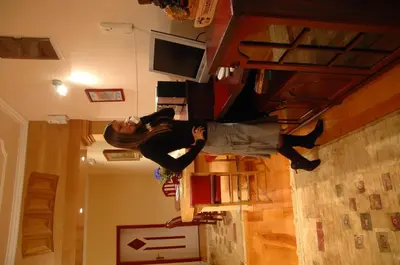 a woman is standing on a staircase in a room at Hotel Tehnograd in Kraljevo
