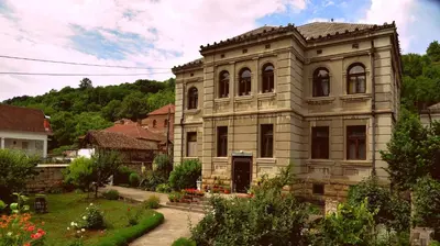 an old stone building with a garden in front of it at Country house Dunjin Konak in Rogljevo