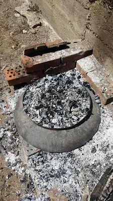 a fire pit in the ground with ashes and rubble at Country house Dunjin Konak in Rogljevo