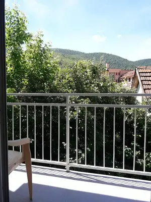 a balcony with a white railing and a bench at Studio S Sokobanja in Soko Banja