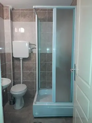 a bathroom with a shower with a toilet and a sink at Studio S Sokobanja in Soko Banja