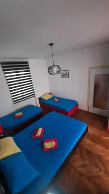 a room with two blue couches and a table at Apartmani LolaNola in Vrnjačka Banja