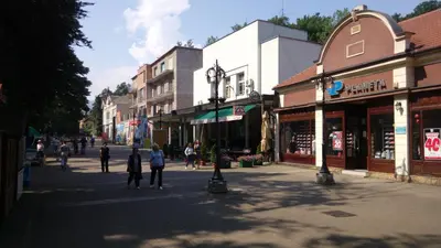 a group of people walking down a city street at Apartmani LolaNola in Vrnjačka Banja