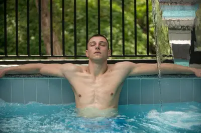 a man is in a swimming pool at B&B Nataly 2 in Soko Banja