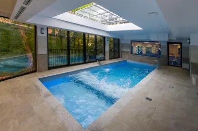 a large swimming pool with a skylight in a house at B&B Nataly 2 in Soko Banja