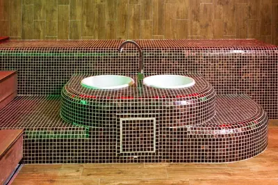 a bathroom with two sinks on a tiled wall at B&B Nataly 2 in Soko Banja