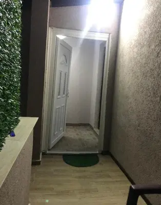 a hallway with a white door and a mirror at Apartments Zlatko in Soko Banja