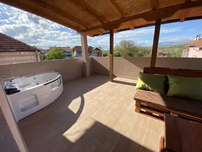 a balcony with a bath tub on a roof at Apartments Zlatko in Soko Banja
