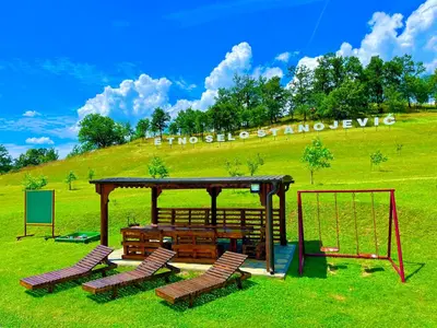 a playground with two chairs and a swing at Etno selo Stanojevic in Boljevac