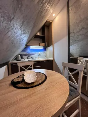 a wooden table with a hat on it in a kitchen at Apartment Maja Konaci in Kopaonik