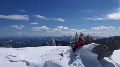 a person standing on top of a snow covered mountain at Apartment Maja Konaci in Kopaonik