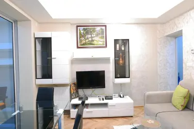 a living room with a tv and a couch at Apartment Zavičaj in Vrnjačka Banja