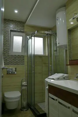 a bathroom with a shower and a toilet and a sink at Apartment Zavičaj in Vrnjačka Banja