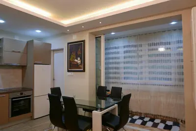a dining room with a glass table and chairs at Apartment Zavičaj in Vrnjačka Banja