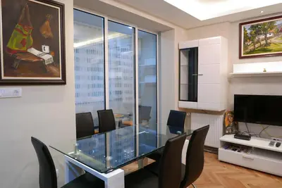 a dining room with a glass table and chairs at Apartment Zavičaj in Vrnjačka Banja
