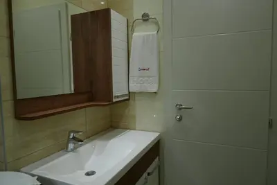 a bathroom with a sink and a mirror at Apartment Zavičaj in Vrnjačka Banja