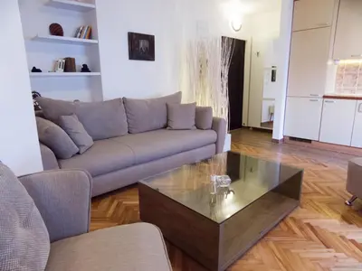 a living room with a couch and a coffee table at Apartment Niš Center in Niš