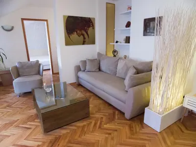 a living room with a couch and a coffee table at Apartment Niš Center in Niš