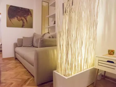 a living room with a couch and a table at Apartment Niš Center in Niš