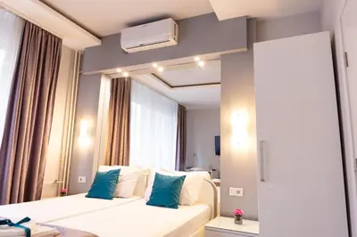a hotel room with a bed and a mirror at SPA Apartment Nalis in Niš