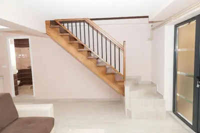 a staircase in a living room with a couch at Prenoćište Kovač in Vranje