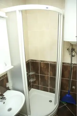 a bathroom with a shower and a toilet and a sink at Apartments Lukic in Vrnjačka Banja