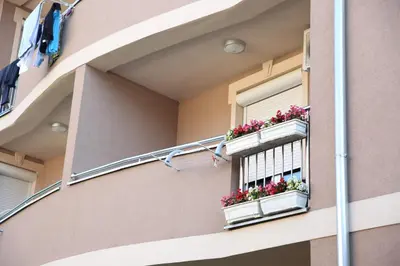 a window with flower boxes on a building at Apartments Lukic in Vrnjačka Banja