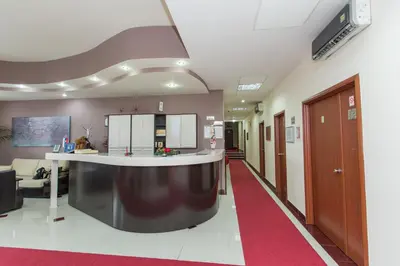 an empty hospital hallway with a red carpet at Sin-Kom Hotel Garni in Pirot