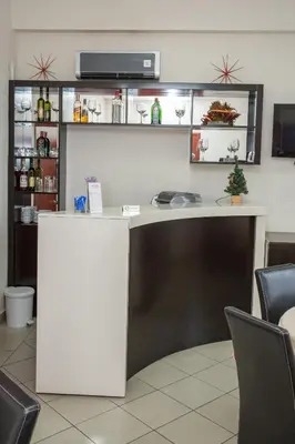 a white desk in a room with chairs at Sin-Kom Hotel Garni in Pirot