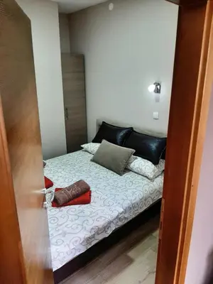 a bedroom with a bed with two shoes on it at Apartmani Radulović in Vrnjačka Banja