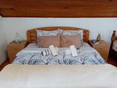 a bedroom with a bed with two pillows at Vila Lenka Sokobanja in Soko Banja