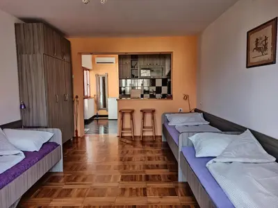 a room with two beds and a kitchen at Apartman Ristic in Niška Banja