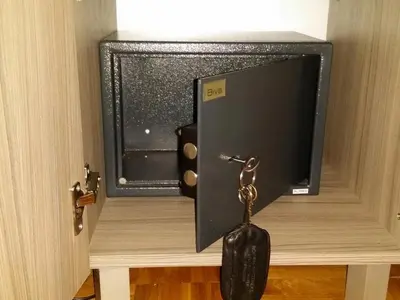 a key hanging from a door with a tv at Apartman Ristic in Niška Banja