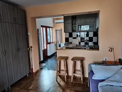 a kitchen with two bar stools and a counter top at Apartman Ristic in Niška Banja